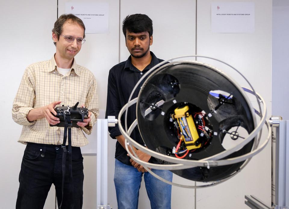 Researchers Rodrigo Ventura and Lakshmi Prasad with SpaceCoBot